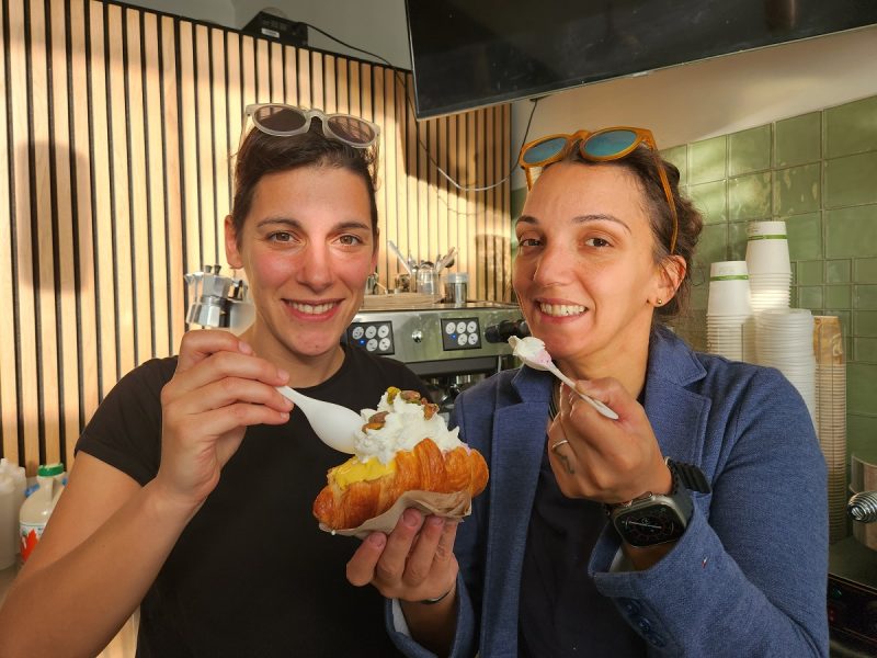 two women eating dessert.