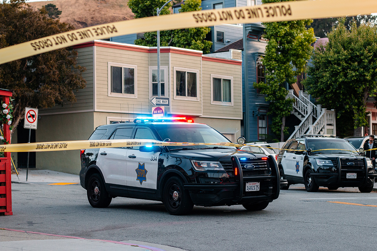 A police car and police line yellow tape.