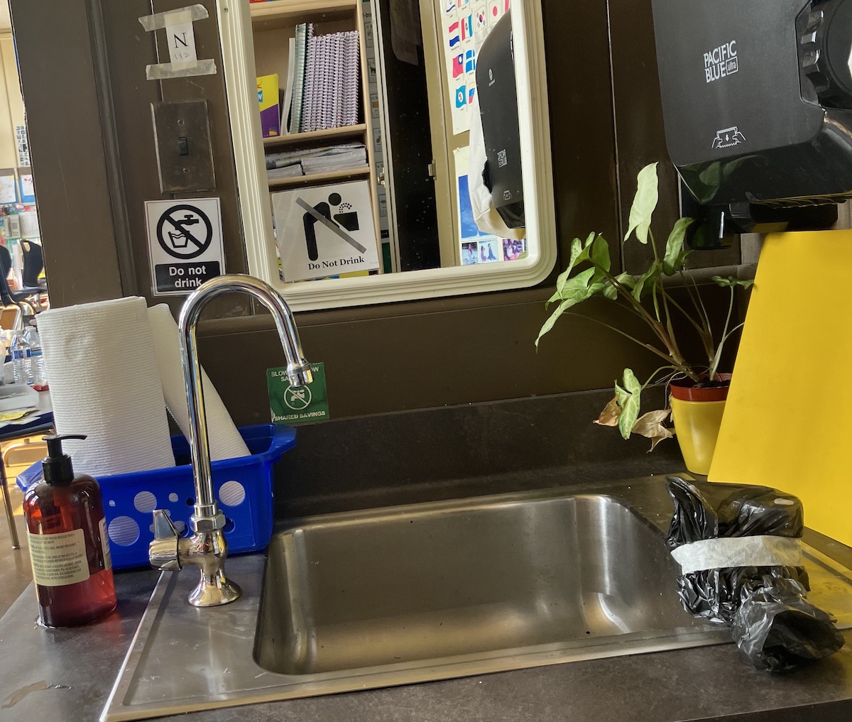 A sink with a plastic bag on it.