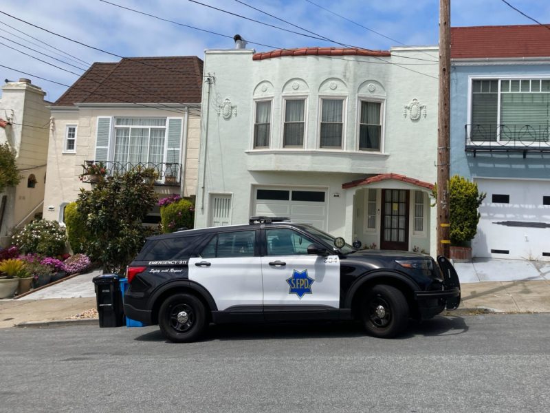 sfpd suv parked in front of two story house