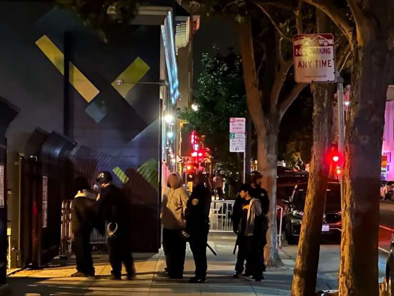 teenagers held zip tied behind their backs on a sidewalk late at night