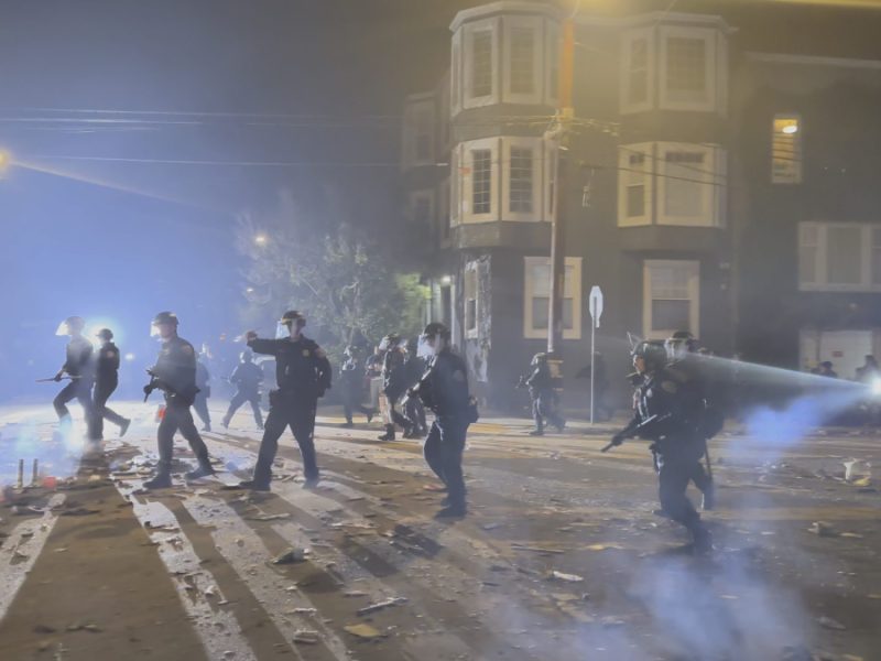 police officers running and shining flashlights