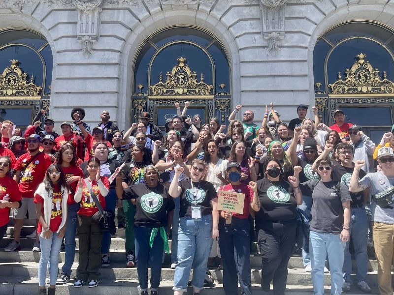 A large group of people in front of a building.