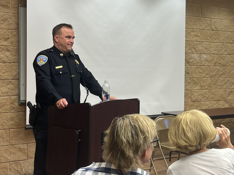 A man in a San Francisco Police Department uniform stands at a podium.