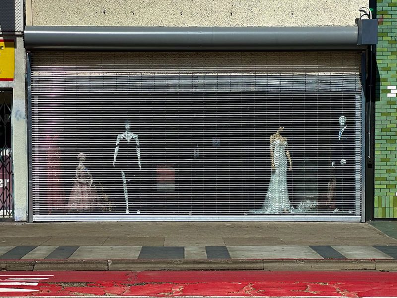 The front of a store with the grate pulled down.