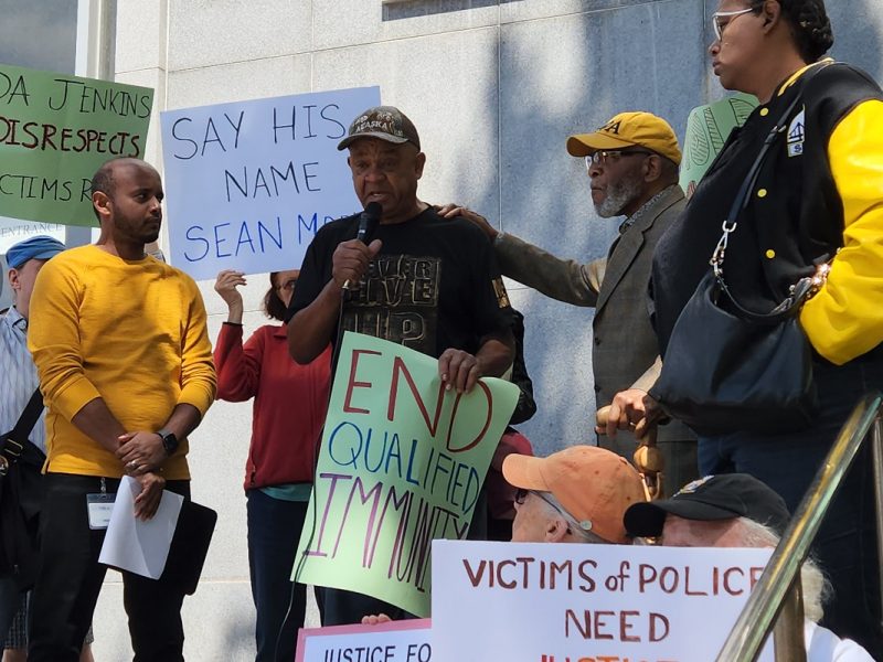 Protesters standing on the steps outside the Hall of Justice.