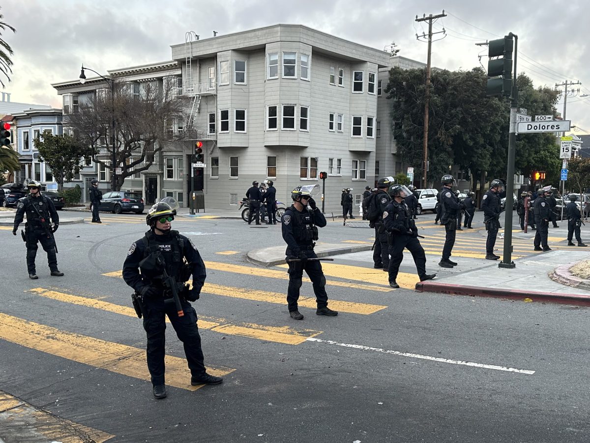 San Francisco police officers lined up at the intersection of 19th and Dolores streets during the shutdown of the hill bomb.