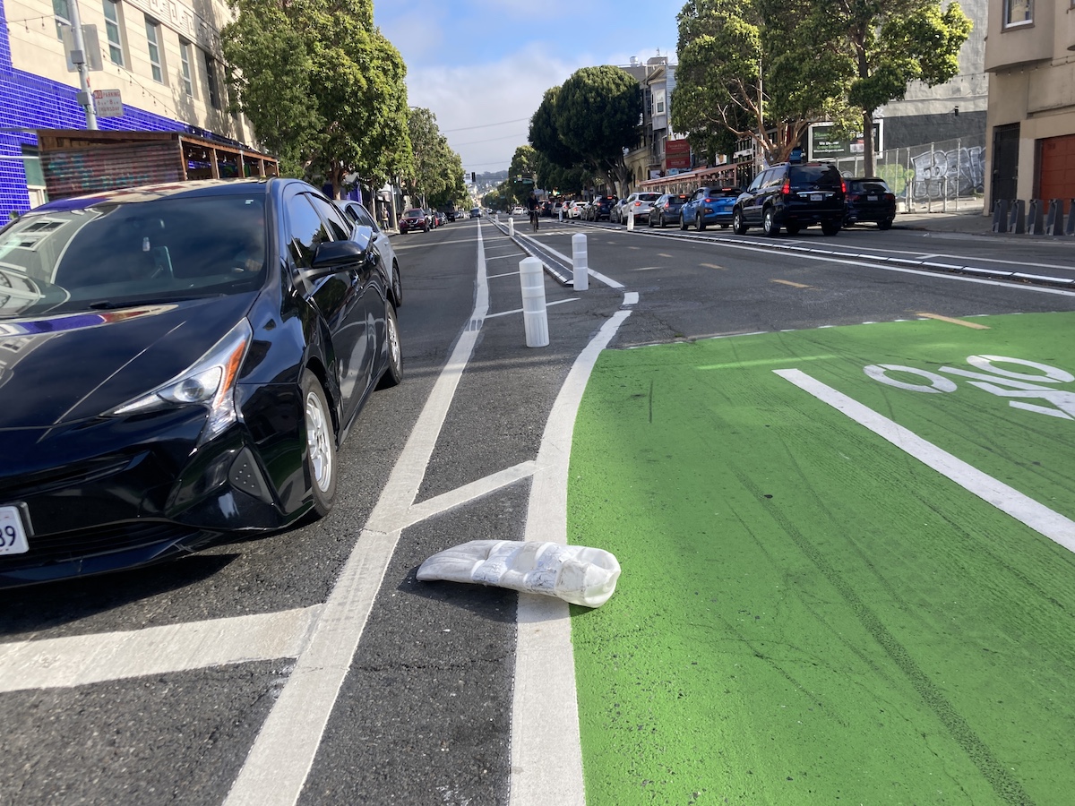a crushed bollard adjacent the center bikeway