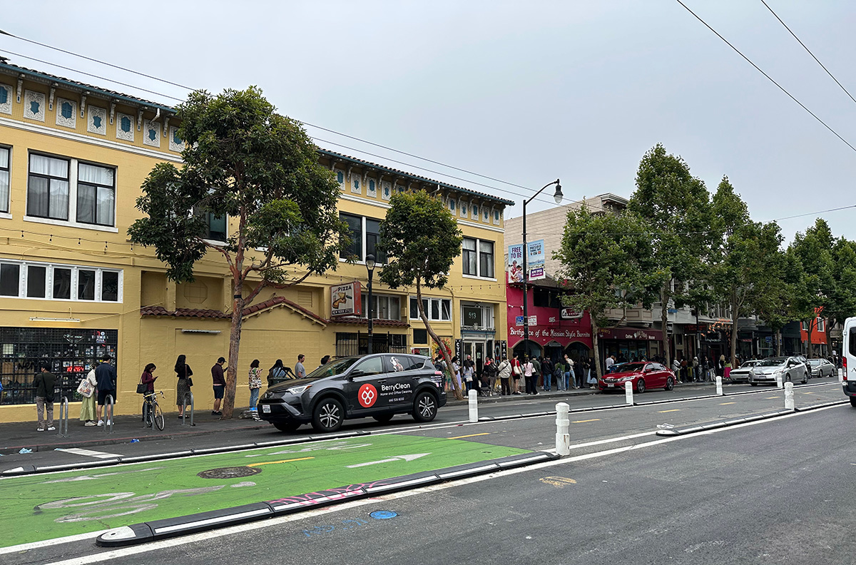 A line of people on a city street.