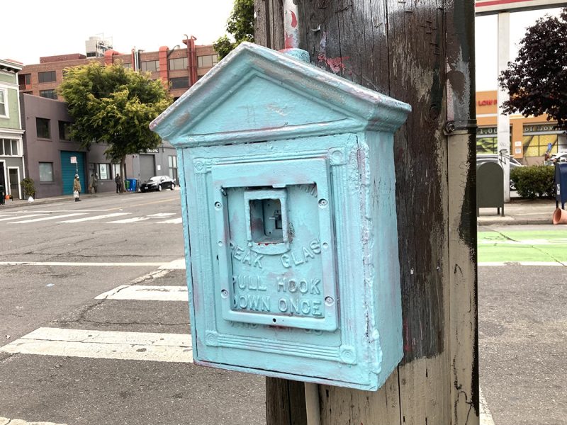 A blue box on a utility pole.