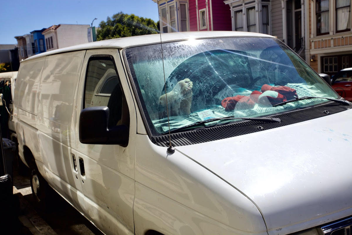 feet up on the dash of a parked white van