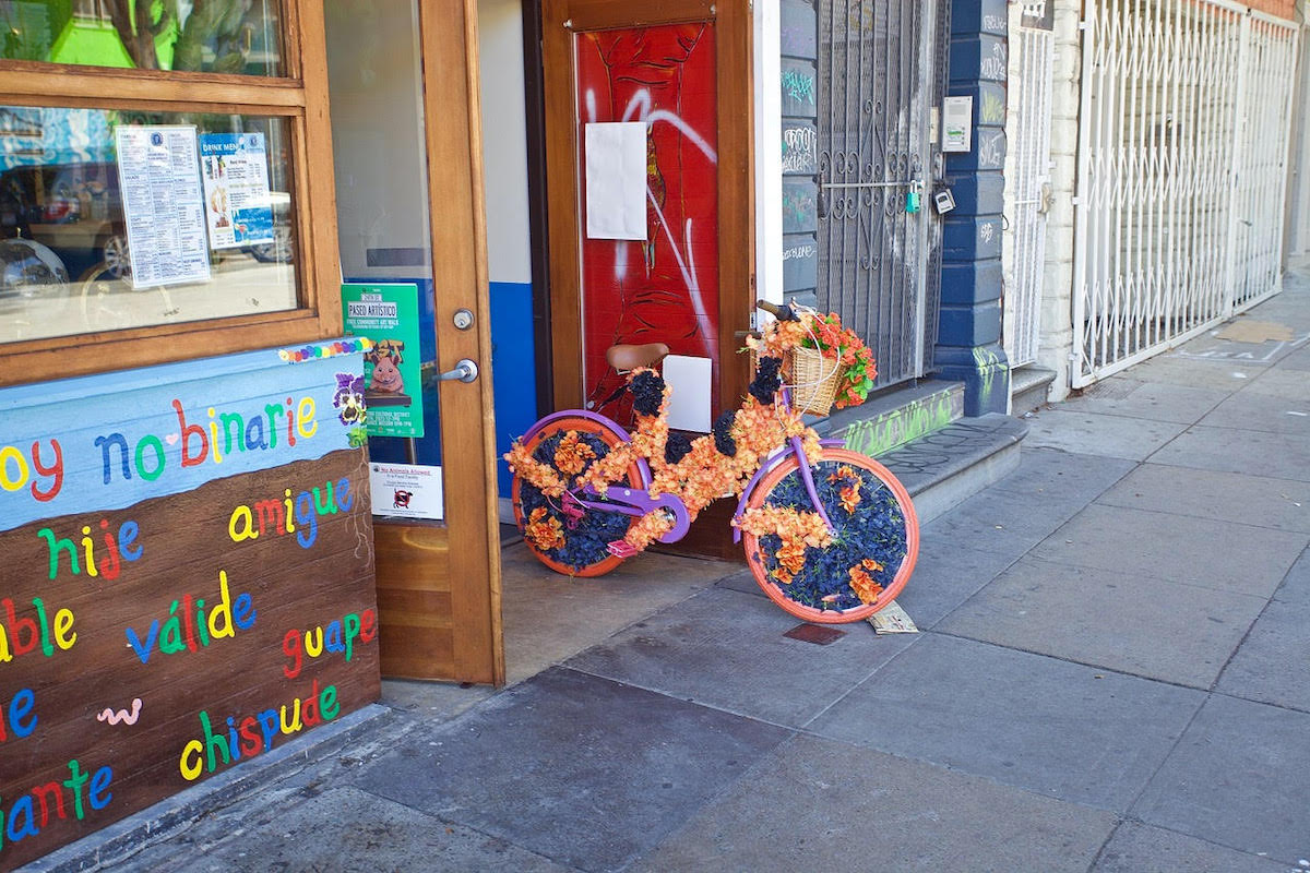 A bicycle in a doorway, decorated with flowers