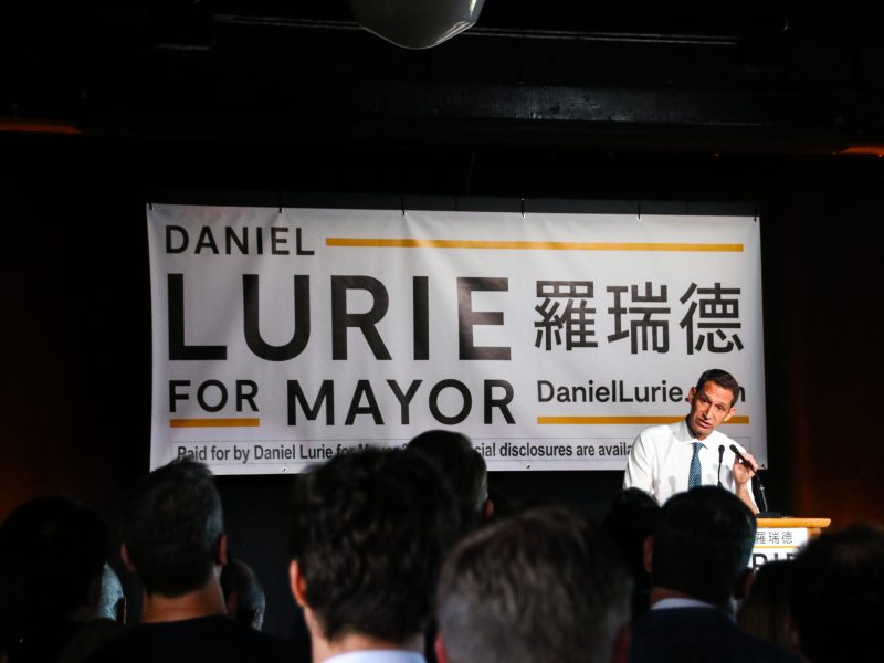 Daniel Lurie on stage giving a speech
