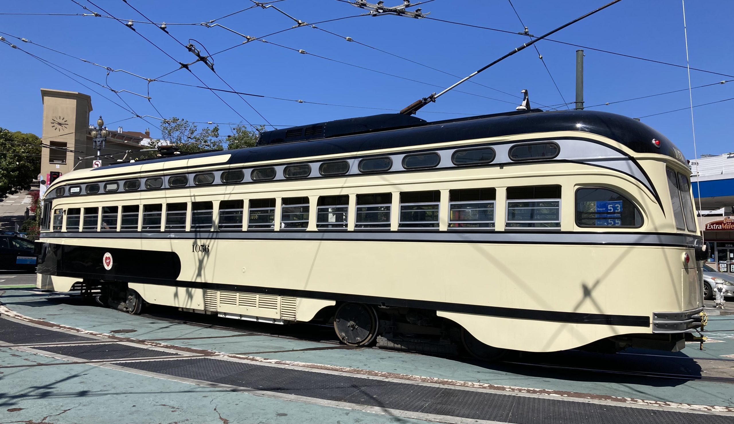 A beige color train with the number 1056 on it on Market Street.