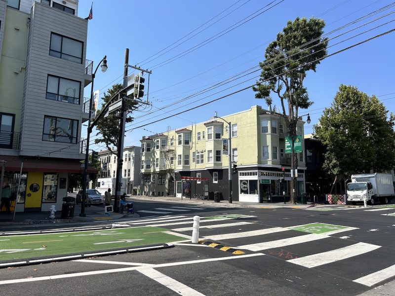 A white crosswalk and a bike lane is pictured at 18th and Valencia streets, where a man was struck by a car.
