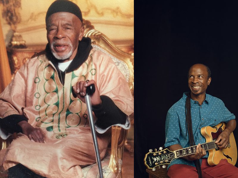 A photo of an older man,sitting with a cane and a pink shirt. And to the right a young man in a blue/green shirt, and a guitar.