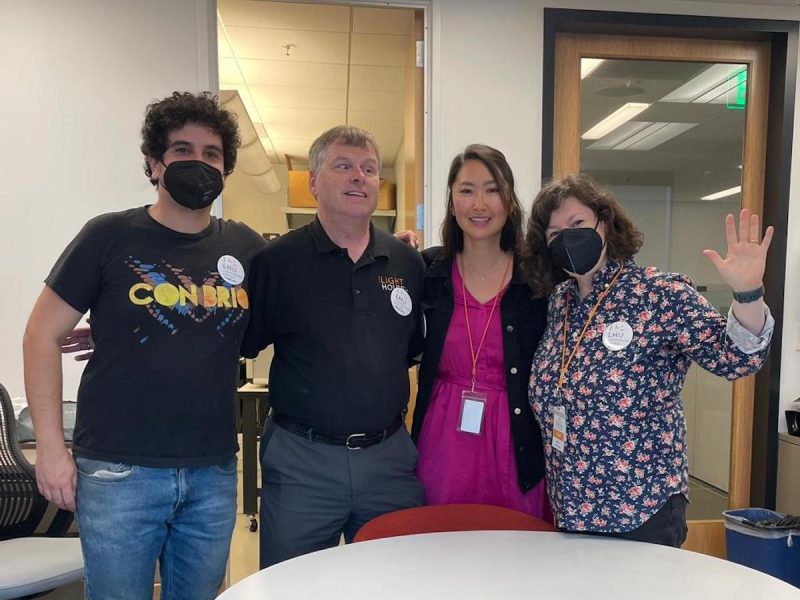 Four people hugging each other.