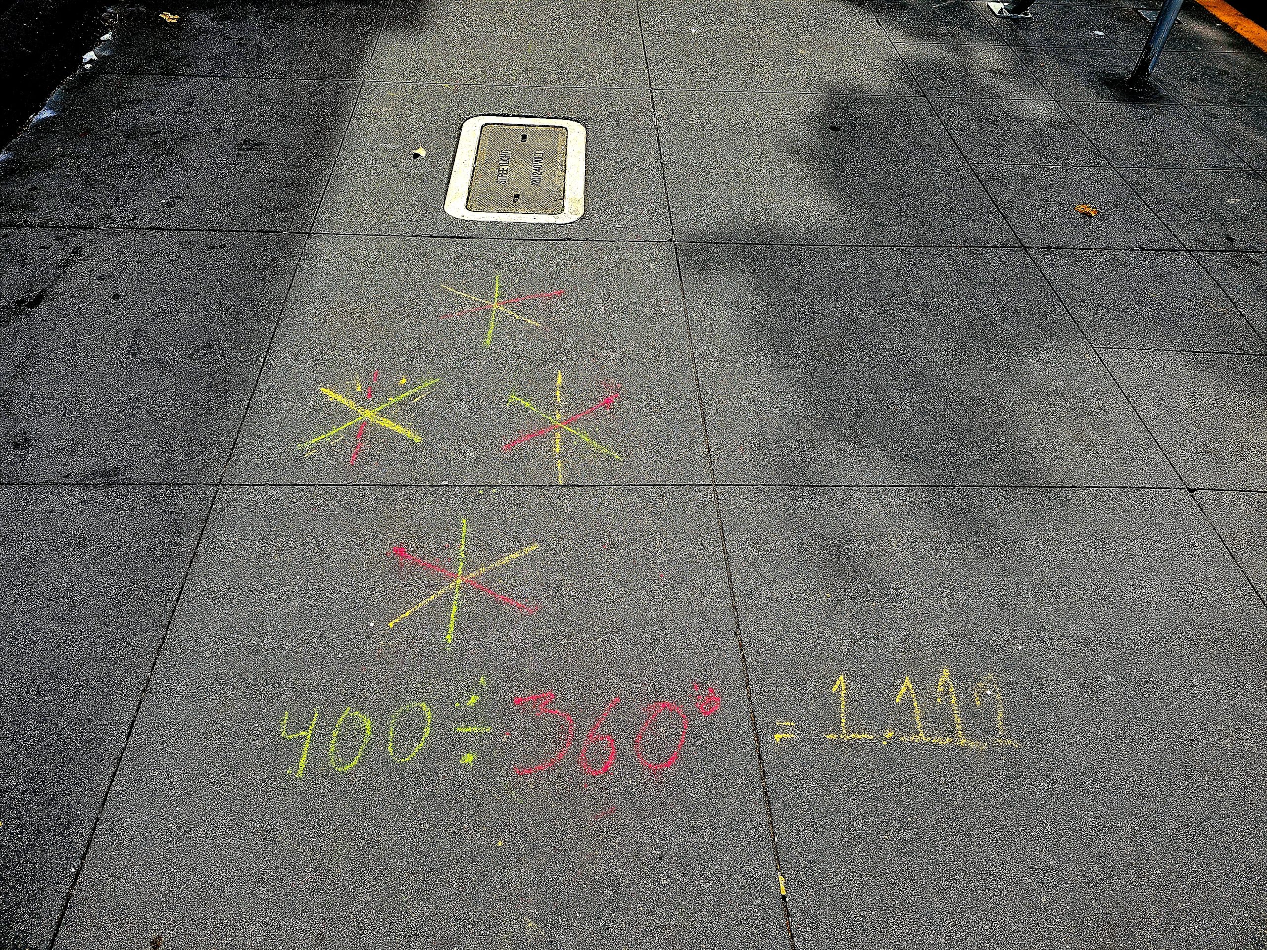 A sidewalk with a tic-tac-toe board drawn on it.