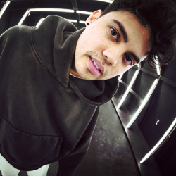 A man wearing a black hoodie.