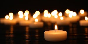 A group of candles on a dark background.