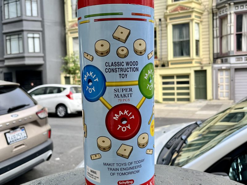 A can of tinkertoys sitting on a street corner.