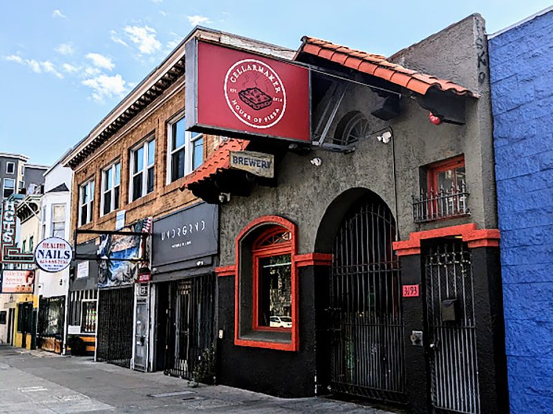 A building with a red and blue sign on the side of it.