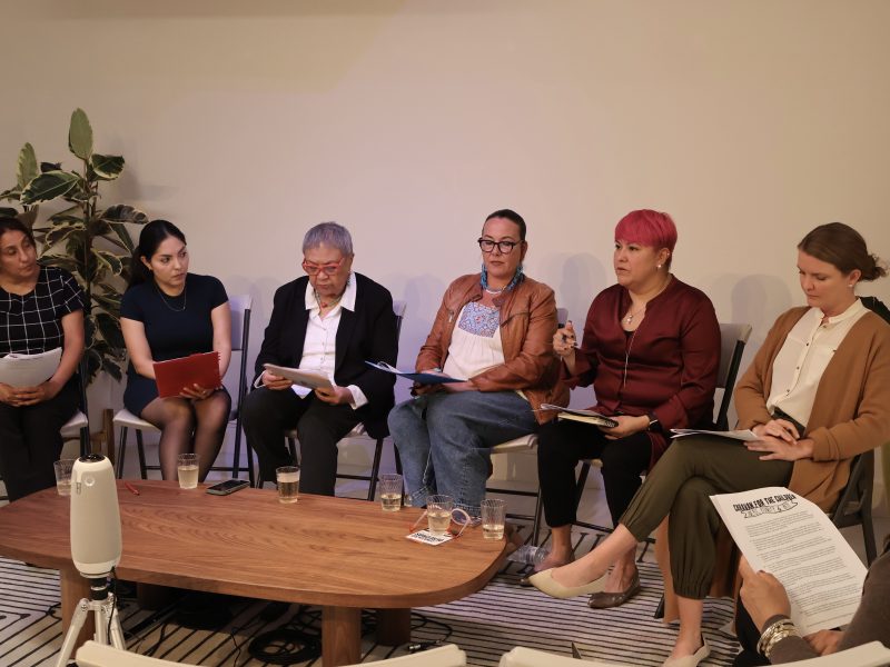 Six women sitting around a table.