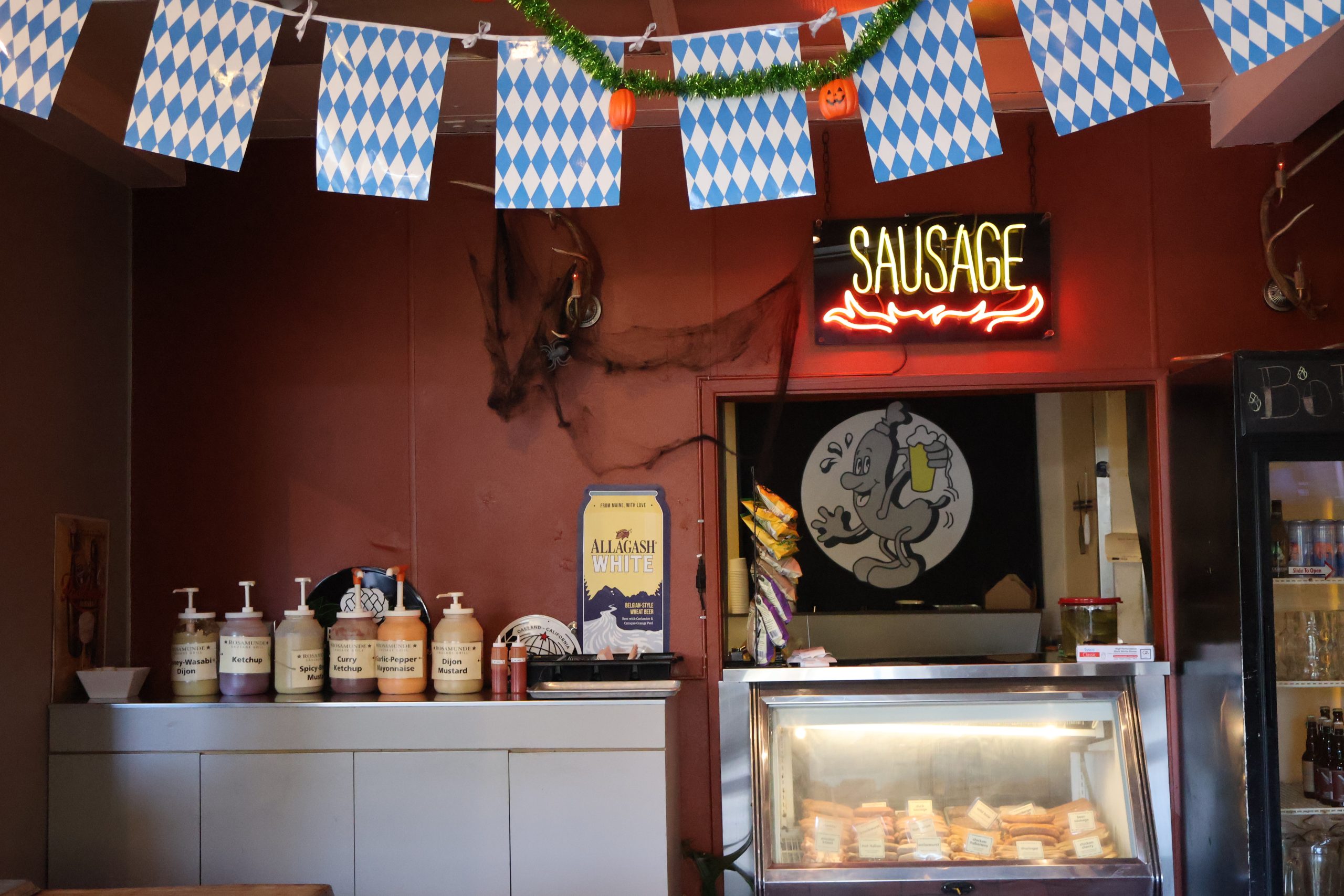 A counter with a display of sausages