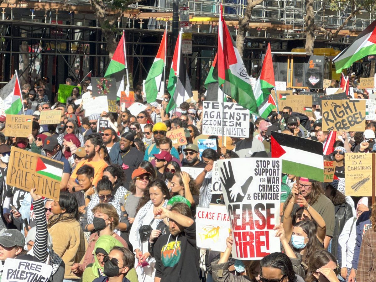 A group of pro-Palestine protesters marching down Market Street in San Francisco.