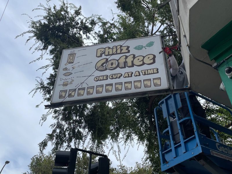 Philz Coffee shop sign being dismantled on Monday, Oct. 16. Photo by Yujie Zhou.