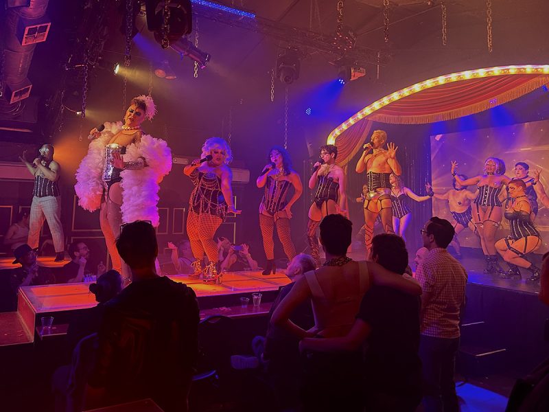 A group of people on stage in a club.