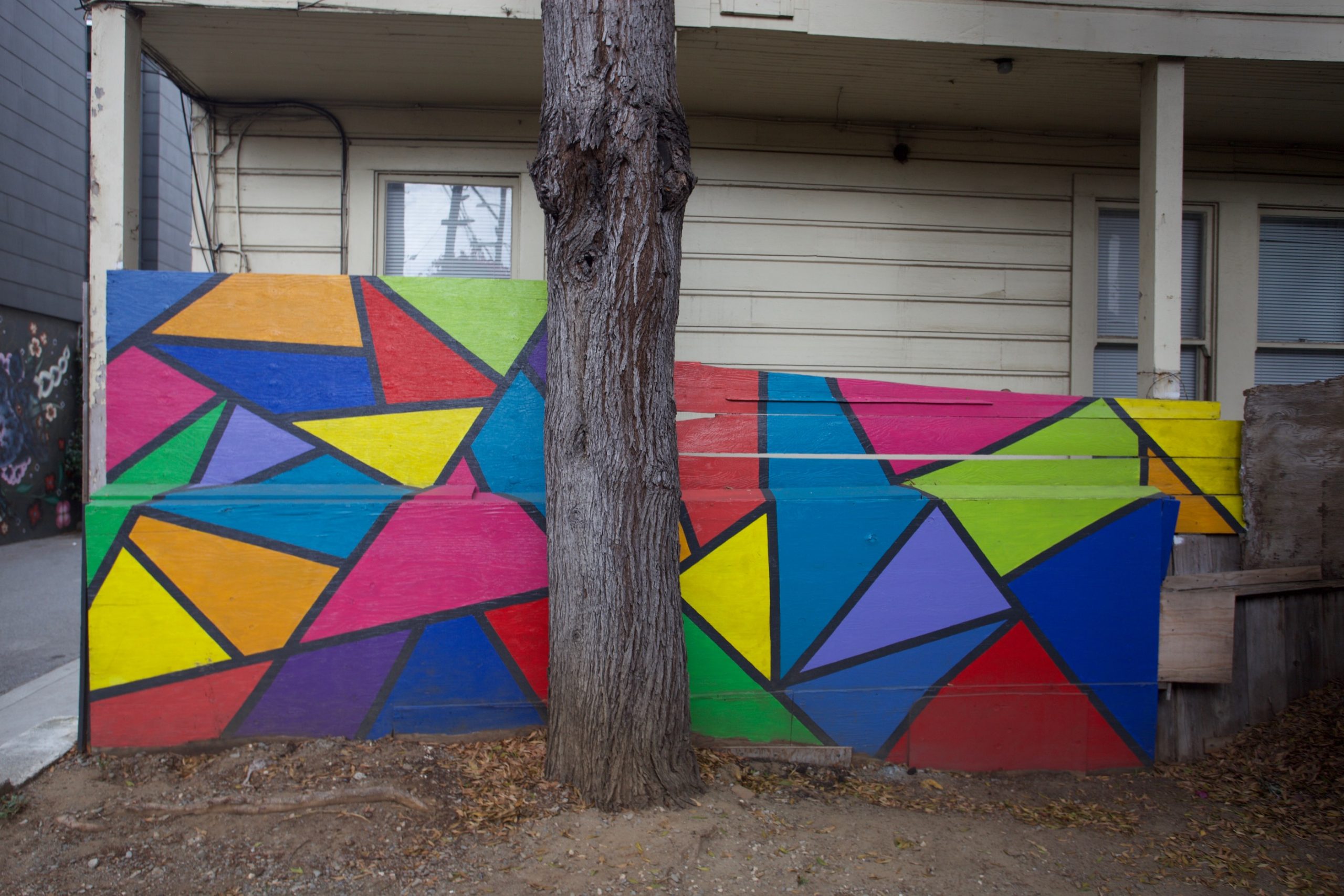 A colorful mural painted on the side of a building.