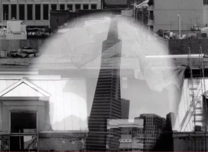 A black and white photo of a building and a skyscraper.