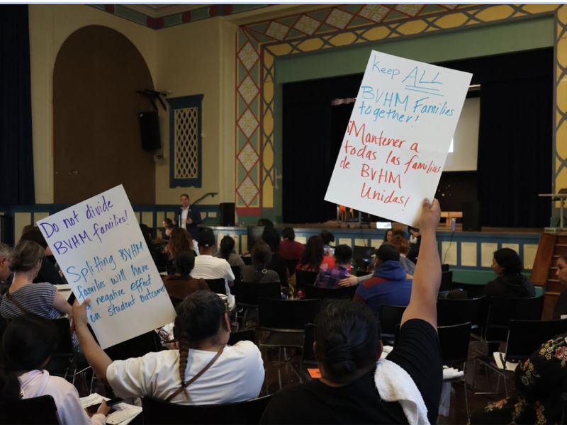 A group of people from Buena Vista Horace Mann K-8 holding signs in a room.