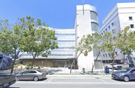 A building with parked cars in front of it in San Francisco.