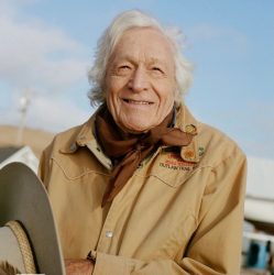 An older man wearing a cowboy hat and a cowboy hat.