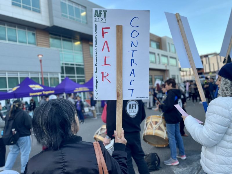 A group of people holding signs that say fair contract at City College of San Francisco.