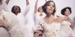 A group of women are doing yoga on a white background.