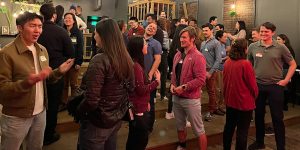 A group of people standing in a room.