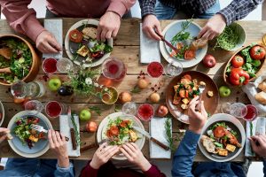 A group of people sitting around a table eating food.