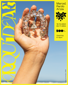 A woman holding a horseshoe.