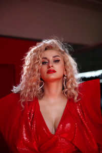 A woman in a red dress posing for a photo.