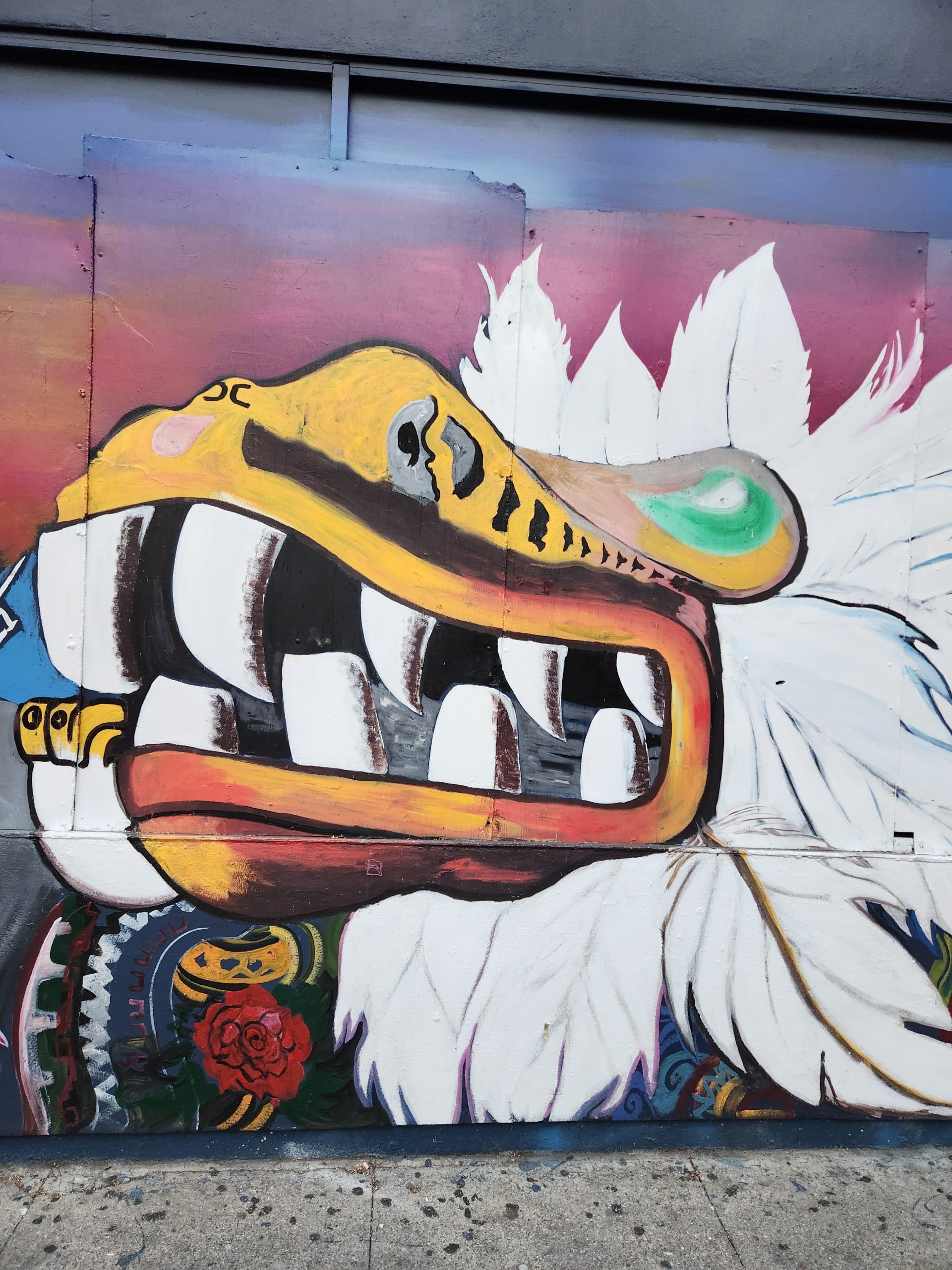 A mural of a dragon painted on the side of a building.