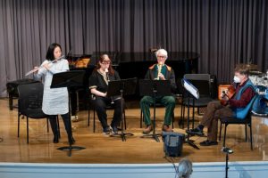 A group of people playing instruments on stage.