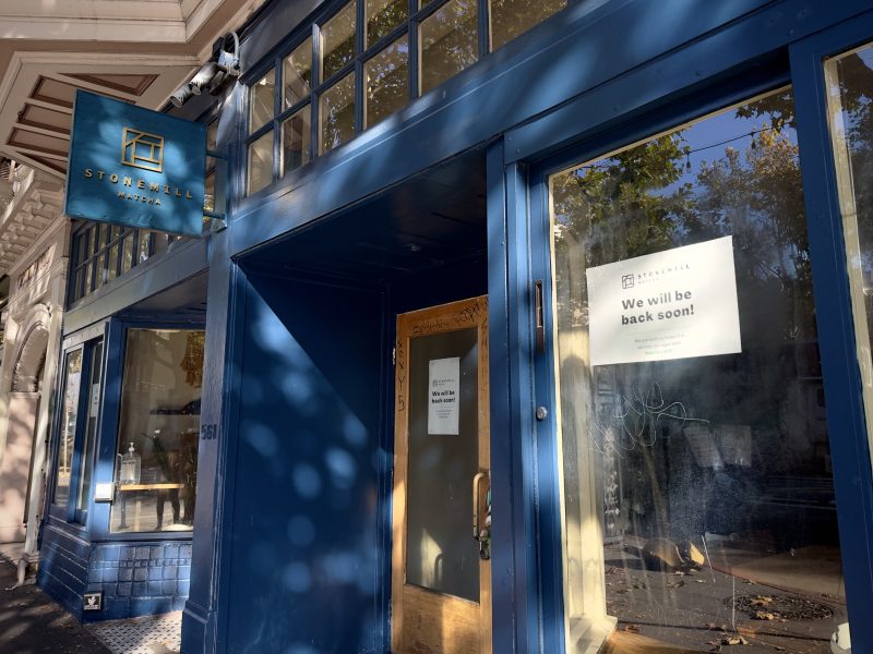 A blue door with a sign on it advertising Stonemill Matcha.