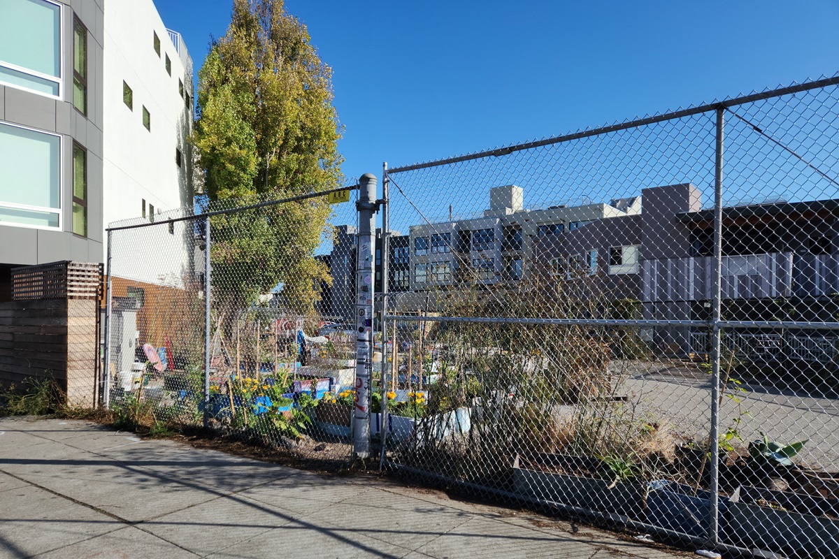 A chain link fence in front of Parcel 36