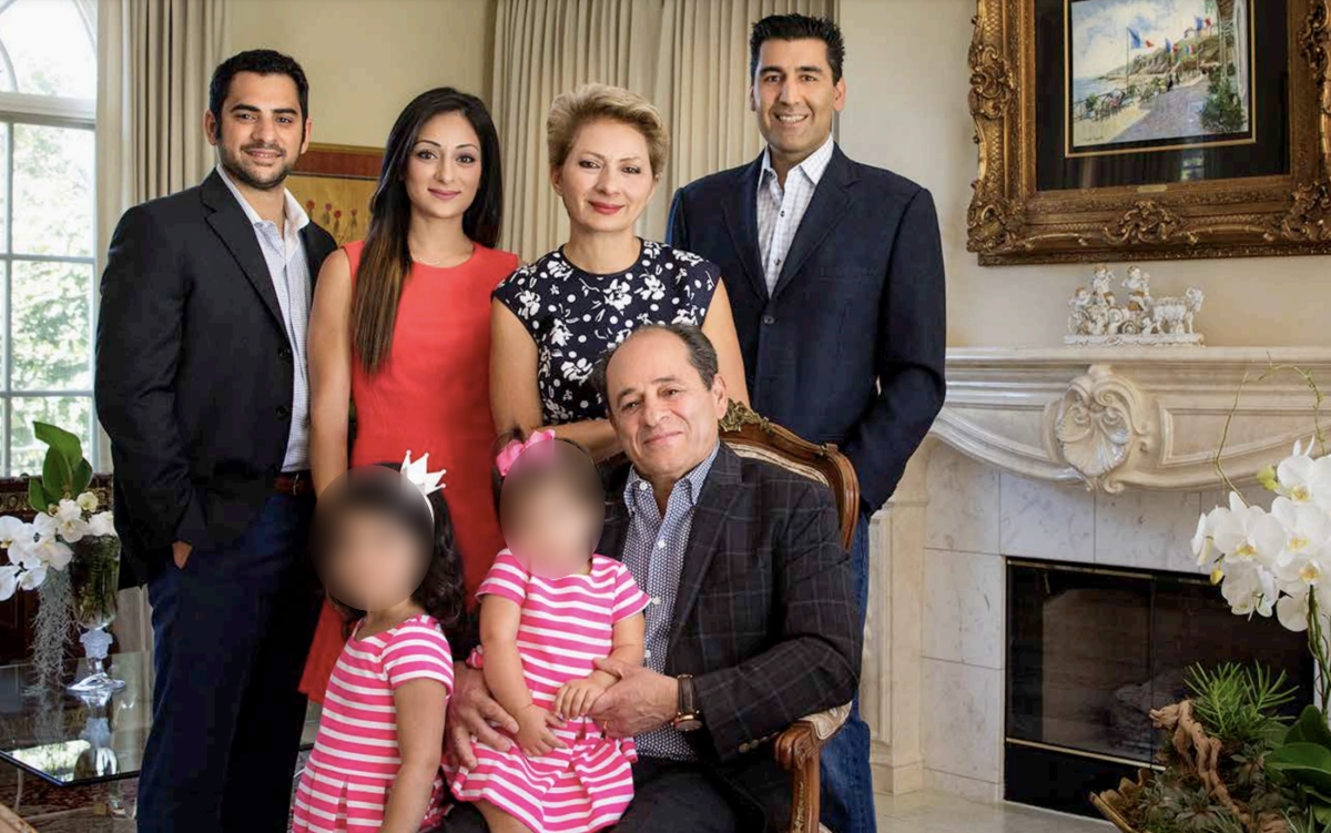 A family posing for a photo in a living room.