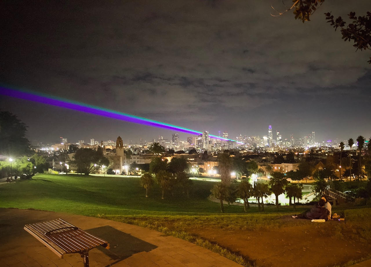 Rainbow night light over San Francisco observed from Dolores Park.