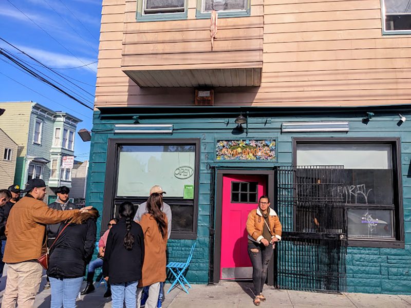 A group of people standing outside of a building.