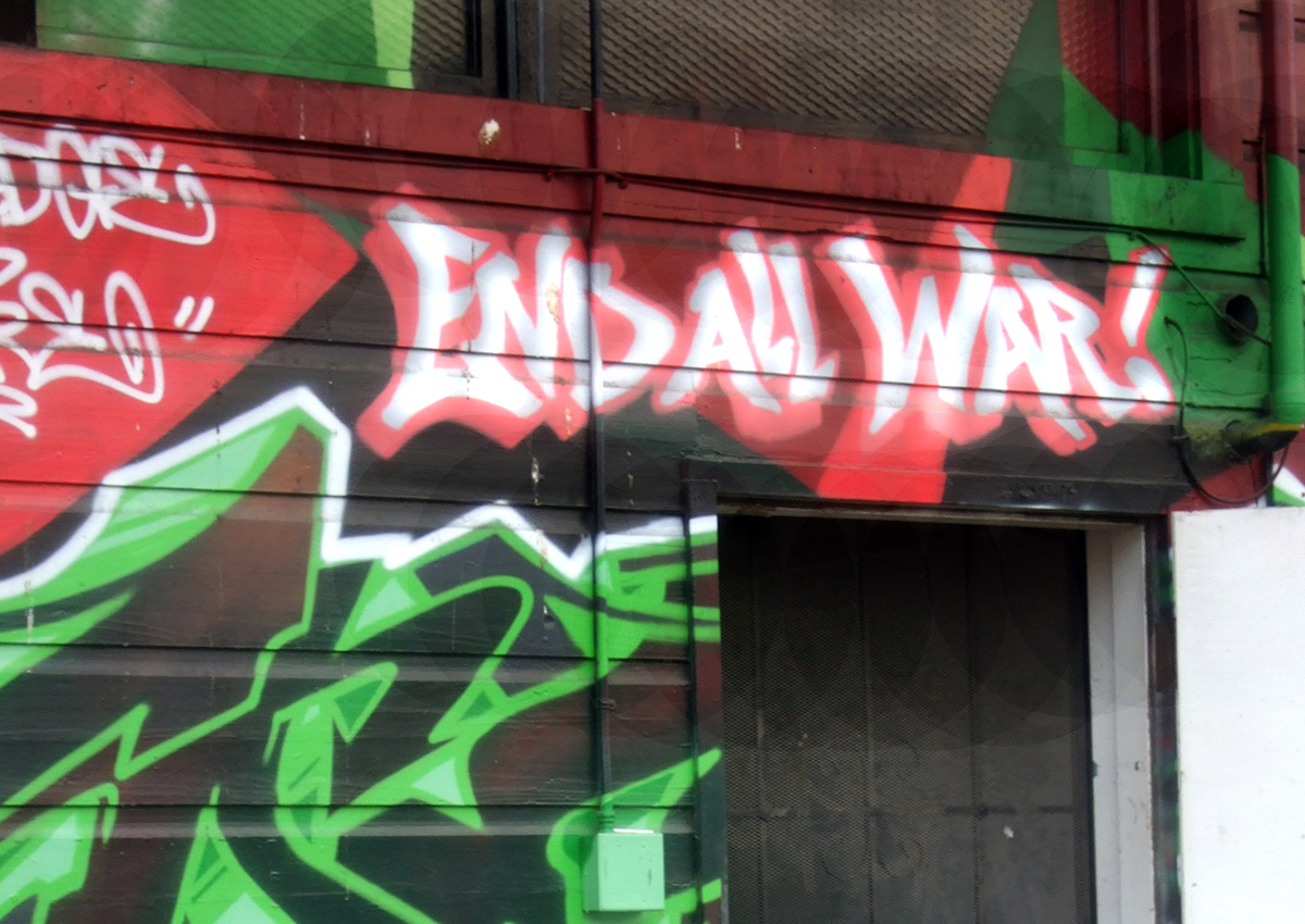 A building with graffiti on it that says End All War.